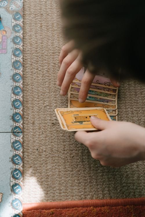 Family playing board game together - indoor activities for kids that build strategic thinking