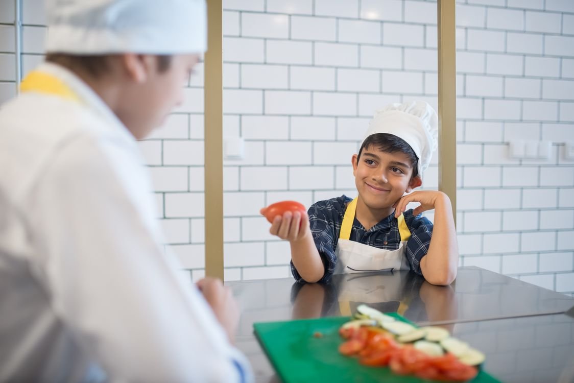 Kids cooking together in the kitchen - fun indoor activities that teach math skills